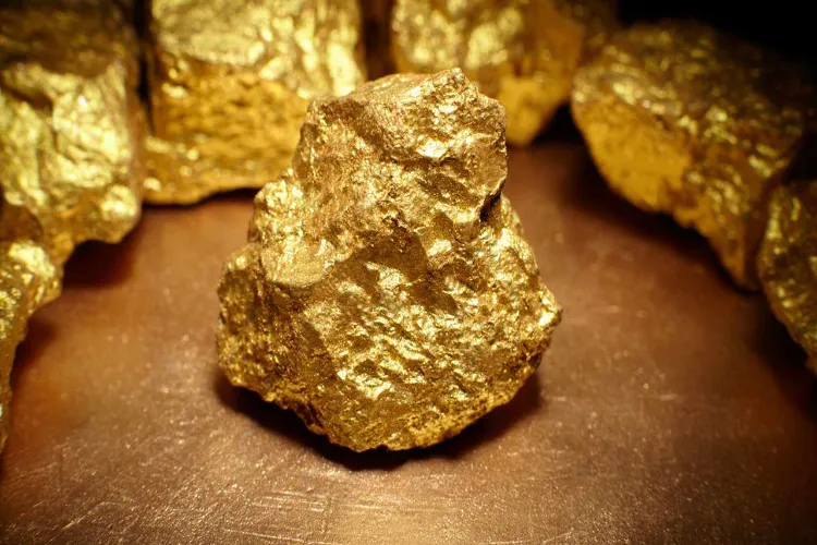 Global gold prices fall to their lowest level in 12 years, with stronger dollar and trade talks bringing relief to investors.