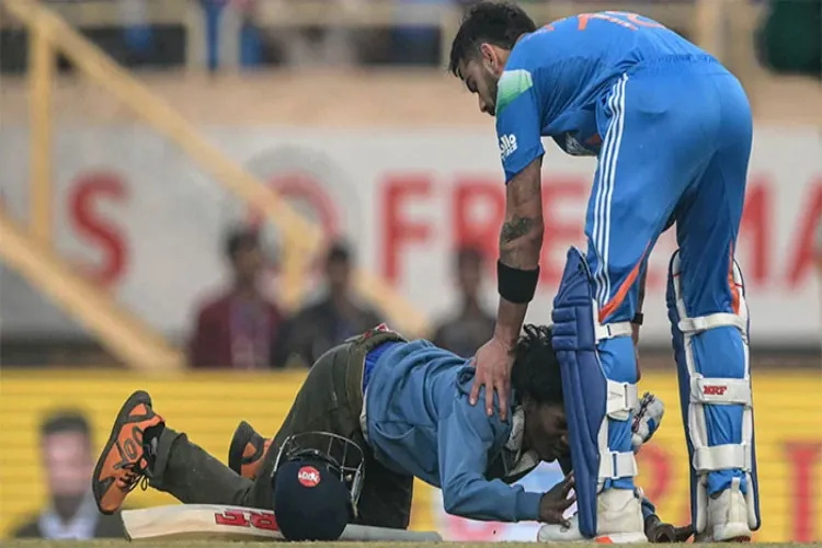 Kohli fan enters the field during match, falls down to touch his feet, immediately gets up