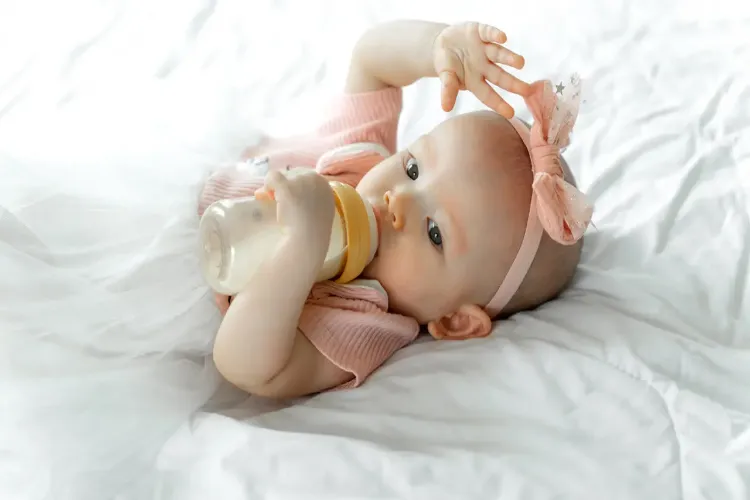 Why can giving cow's milk to children under 12 months of age be harmful?