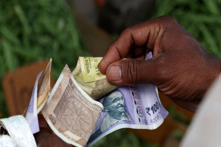 Rupee gains 12 paise to 95.05 per dollar