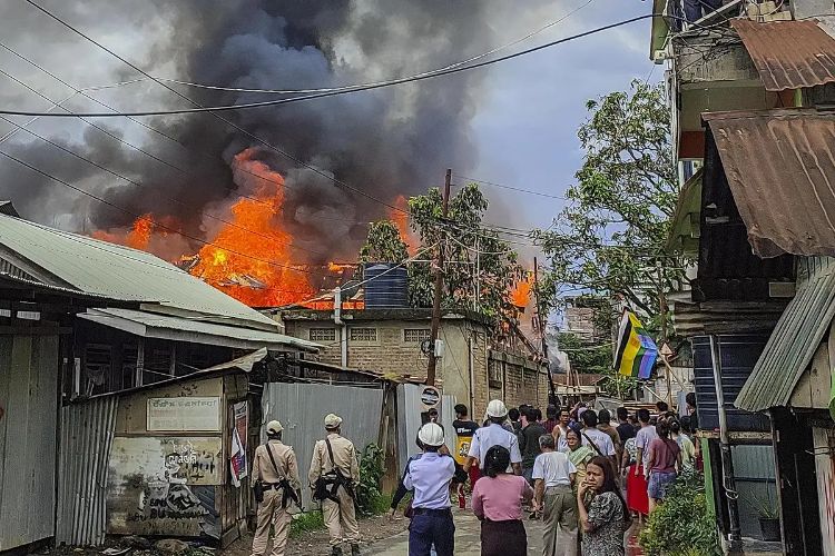 Suspected militants set fire to several houses in an abandoned village in Manipur, raising tensions.